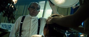 Movie still from “Deadpool 2” (2018), directed by David Leitch – A man in a white shirt is holding up a light; Medium shot, Low angle