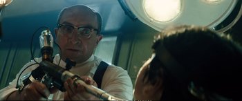 Movie still from “Deadpool 2” (2018), directed by David Leitch – A man with glasses and a tie is looking into a mirror; Close Up shot, Low angle