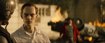 Movie still from “Deadpool 2” (2018), directed by David Leitch – A young man standing in front of a fireplace; Close Up shot, Over the shoulder angle