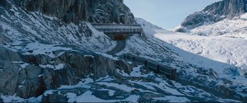 Movie still from “Deadpool 2” (2018), directed by David Leitch – A train traveling on a train track near a bridge; Extreme Wide shot, High angle