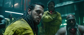 Movie still from “Deadpool 2” (2018), directed by David Leitch – A man with dreads is looking at the camera while another man with dreadlocks stands behind him; Close Up shot, Low angle