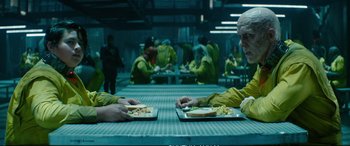 Movie still from “Deadpool 2” (2018), directed by David Leitch – Two people sitting at a table with plates of food on it; Medium shot, Over the shoulder angle