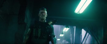 Movie still from “Deadpool 2” (2018), directed by David Leitch – A man with a gun in his hand; Medium shot, Low angle