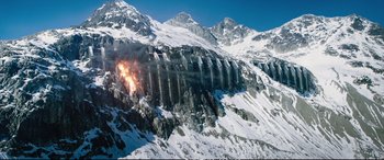 Movie still from “Deadpool 2” (2018), directed by David Leitch – A fire is burning in the middle of a snowy mountain; Extreme Wide shot, Low angle