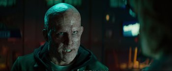 Movie still from “Deadpool 2” (2018), directed by David Leitch – An old man with a shaved head and blue eyes; Close Up shot, Low angle