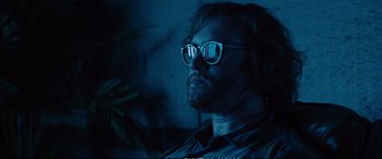 Movie still from “Deadpool 2” (2018), directed by David Leitch – A man with glasses is looking into the distance; Close Up shot, Low angle