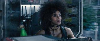 Movie still from “Deadpool 2” (2018), directed by David Leitch – A woman sitting in a chair with a large black afro; Close Up shot, Low angle