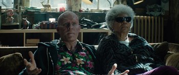 Movie still from “Deadpool 2” (2018), directed by David Leitch – An older man sitting next to an older woman; Medium shot, Over the shoulder angle