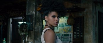 Movie still from “Deadpool 2” (2018), directed by David Leitch – A woman with a black afro is posing for a picture; Close Up shot, Low angle