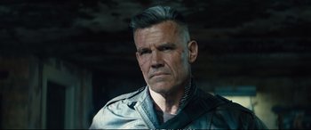 Movie still from “Deadpool 2” (2018), directed by David Leitch – A person wearing a leather jacket; Close Up shot, Over the shoulder angle