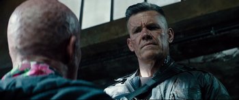 Movie still from “Deadpool 2” (2018), directed by David Leitch – A person with a beard; Close Up shot, Over the shoulder angle
