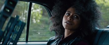 Movie still from “Deadpool 2” (2018), directed by David Leitch – A woman sitting in the passenger seat of a car looking out the window; Close Up shot, Over the shoulder angle