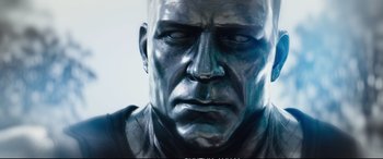 Movie still from “Deadpool 2” (2018), directed by David Leitch – The face of a man in a silver suit; Extreme Close Up shot, Low angle