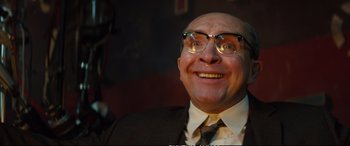 Movie still from “Deadpool 2” (2018), directed by David Leitch – A man in a suit and tie with glasses on; Close Up shot, Low angle