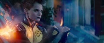 Movie still from “Deadpool 2” (2018), directed by David Leitch – A woman dressed in a yellow and black costume; Close Up shot, Over the shoulder angle