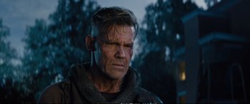 Movie still from “Deadpool 2” (2018), directed by David Leitch – A man that is looking into the distance; Close Up shot, Over the shoulder angle