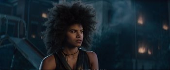 Movie still from “Deadpool 2” (2018), directed by David Leitch – A woman with a large afro is standing in a dark room; Close Up shot, Low angle