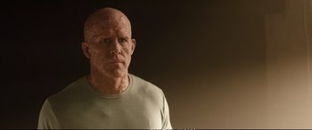 Movie still from “Deadpool 2” (2018), directed by David Leitch – An old man with a bald head wearing a green shirt; Close Up shot, Low angle