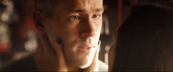 Movie still from “Deadpool 2” (2018), directed by David Leitch – A man's face in a bathroom mirror; Close Up shot, Over the shoulder angle