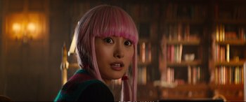 Movie still from “Deadpool 2” (2018), directed by David Leitch – A woman with pink hair is looking at the camera; Close Up shot, Over the shoulder angle