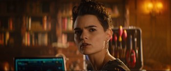 Movie still from “Deadpool 2” (2018), directed by David Leitch – A woman with short brown hair wearing ear cuffs; Close Up shot, Over the shoulder angle