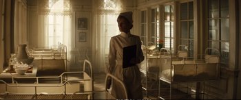 Movie still from “Deadpool 2” (2018), directed by David Leitch – A woman dressed as a nurse holding a book; Medium shot, Low angle