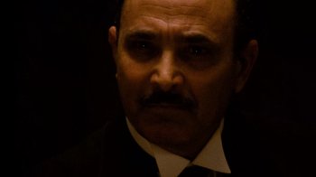 Movie still from “The Godfather” (1972), directed by Francis Ford Coppola – A person wearing a suit and tie; Close Up shot, Low angle