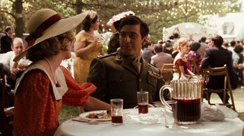 Movie still from “The Godfather” (1972), directed by Francis Ford Coppola – A man and a woman are sitting at a table; Medium shot, Over the shoulder angle