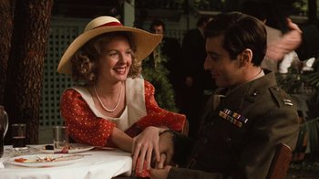 Movie still from “The Godfather” (1972), directed by Francis Ford Coppola – A man and a woman sitting next to each other at a table; Medium shot, Low angle