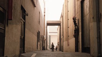 Movie still from “The Godfather” (1972), directed by Francis Ford Coppola – Two people walking down a narrow alley way; Extreme Wide shot, High angle
