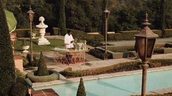Movie still from “The Godfather” (1972), directed by Francis Ford Coppola – A man standing in front of an outdoor fountain; Extreme Wide shot, High angle