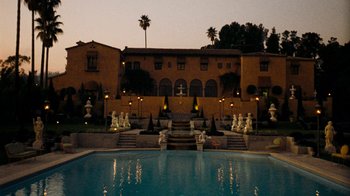 Movie still from “The Godfather” (1972), directed by Francis Ford Coppola – A large pool in front of a large mansion; Extreme Wide shot, High angle