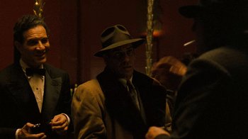 Movie still from “The Godfather” (1972), directed by Francis Ford Coppola – A man in a hat and a suit; Medium shot, Over the shoulder angle