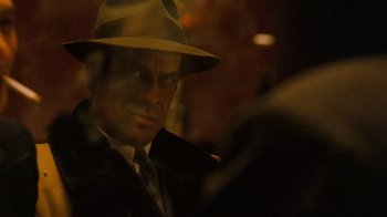 Movie still from “The Godfather” (1972), directed by Francis Ford Coppola – A person wearing a suit and a hat; Close Up shot, Over the shoulder angle
