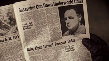 Movie still from “The Godfather” (1972), directed by Francis Ford Coppola – A newspaper article with a picture of a man in the middle; Extreme Close Up shot, Overhead angle