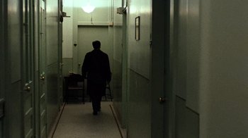 Movie still from “The Godfather” (1972), directed by Francis Ford Coppola – A man walking down a hallway with a cane; Wide shot, High angle