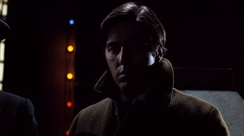 Movie still from “The Godfather” (1972), directed by Francis Ford Coppola – A man in a brown coat is standing in the dark; Close Up shot, Low angle