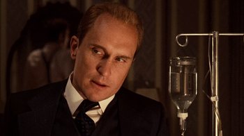Movie still from “The Godfather” (1972), directed by Francis Ford Coppola – A man in a suit and tie next to an infusion bottle; Close Up shot, Low angle