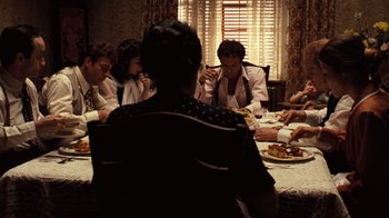 Movie still from “The Godfather” (1972), directed by Francis Ford Coppola – A group of people sitting around a dinner table; Wide shot, High angle