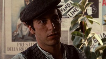 Movie still from “The Godfather” (1972), directed by Francis Ford Coppola – A person wearing a hat; Close Up shot, Over the shoulder angle