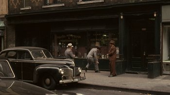 Movie still from “The Godfather” (1972), directed by Francis Ford Coppola – A group of men standing on the side of the street; Extreme Wide shot, High angle