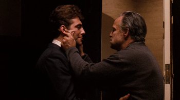 Movie still from “The Godfather” (1972), directed by Francis Ford Coppola – A man putting a tie on another man's neck; Medium shot, Over the shoulder angle