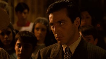 Movie still from “The Godfather” (1972), directed by Francis Ford Coppola – A person wearing a suit and tie; Close Up shot, Over the shoulder angle