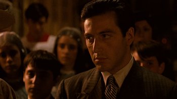 Movie still from “The Godfather” (1972), directed by Francis Ford Coppola – A person wearing a suit and tie; Close Up shot, Over the shoulder angle
