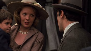 Movie still from “The Godfather” (1972), directed by Francis Ford Coppola – A man and a woman wearing hats talking to each other; Close Up shot, Over the shoulder angle