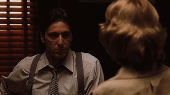 Movie still from “The Godfather” (1972), directed by Francis Ford Coppola – A man in a suit and tie looking at a woman in a dress shirt; Close Up shot, Over the shoulder angle