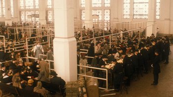 Movie still from “The Godfather Part II” (1974), directed by Francis Ford Coppola – A group of people sitting at tables in a large room; Extreme Wide shot, High angle