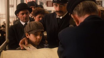 Movie still from “The Godfather Part II” (1974), directed by Francis Ford Coppola – A man and a boy are looking at a map; Medium shot, Over the shoulder angle