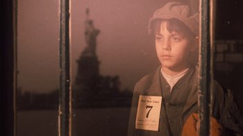 Movie still from “The Godfather Part II” (1974), directed by Francis Ford Coppola – A young boy wearing a hat and a number tag; Close Up shot, Low angle