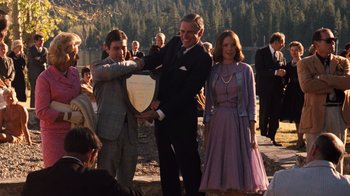Movie still from “The Godfather Part II” (1974), directed by Francis Ford Coppola – A group of people standing next to each other on a beach; Medium shot, Over the shoulder angle